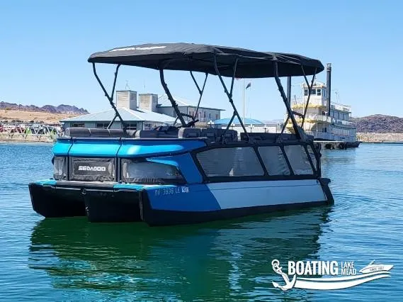 Slide: The Image of 2023 Sea-Doo Switch Cruise 21 pontoon boat on Lake Mead, featuring a sleek design. - 8