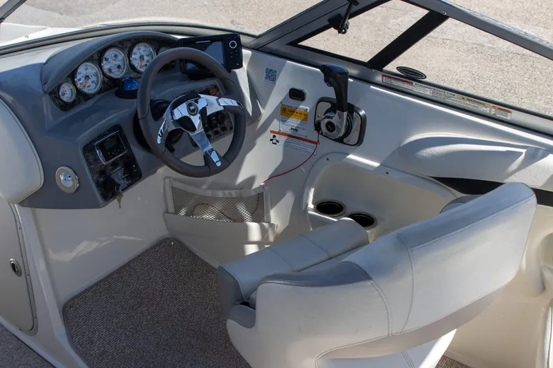 Slide: The Image of 2013 Stingray 225 LR boat cockpit with steering wheel, gauges, and controls. - 5
