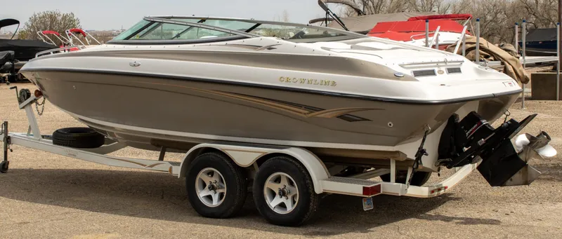 Slide: The Image of 2003 Crownline 225 BR boat on trailer, parked outdoors, side view. - 2