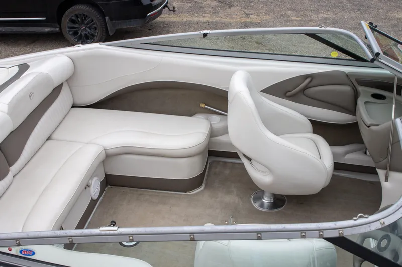 Slide: The Image of 2003 Crownline 225 BR boat interior with white and beige seating, featuring a sleek design. - 5