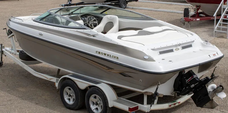 Slide: The Image of 2003 Crownline 225 BR boat on trailer, featuring sleek design and white interior. - 9