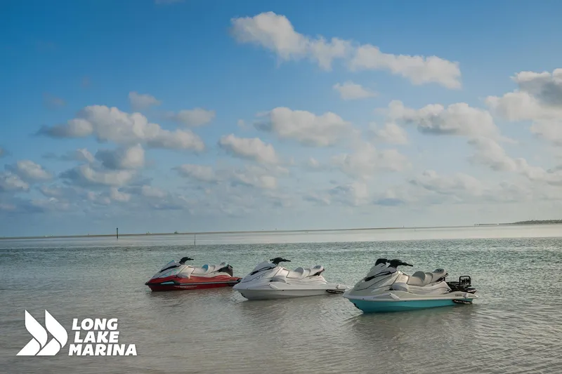Slide: The Image of Three 2025 Yamaha VX Cruiser HO jet skis on calm water at Long Lake Marina. - 3