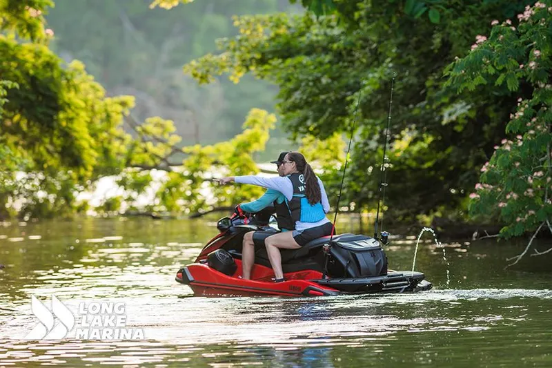 Slide: The Image of 2025 Yamaha VX Deluxe w/ Audio jet ski on a scenic lake, surrounded by lush greenery. - 4