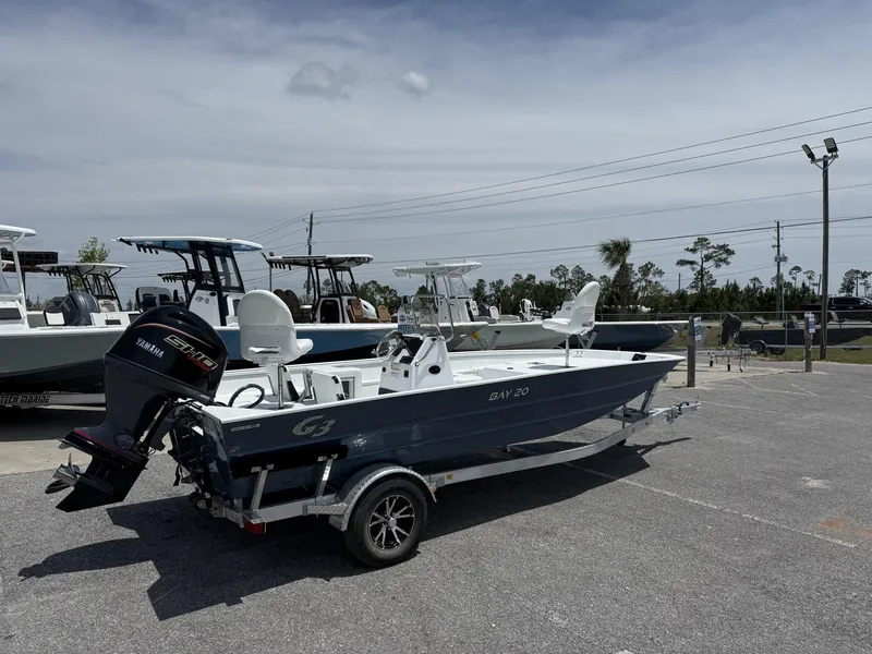 Slide: The Image of 2025 G3 Bay 20 boat on trailer with Yamaha engine, parked outdoors. - 2