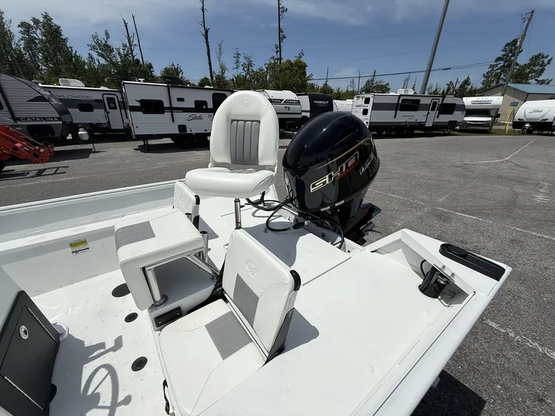 Slide: The Image of 2025 G3 Bay 20 boat with motor, white seating, and RVs in the background. - 4