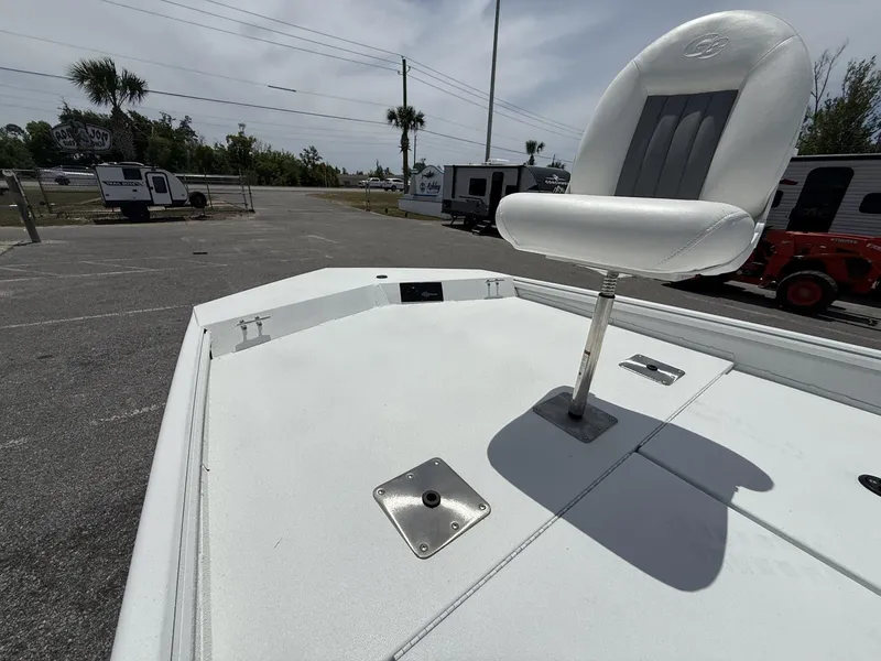 Slide: The Image of 2025 G3 Bay 20 boat with elevated white seat on deck, parked outdoors. - 9