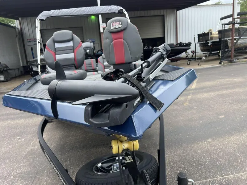Slide: The Image of 2022 Ranger RT178C boat with dual seats and trolling motor in a parking lot. - 17