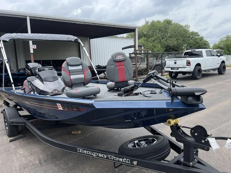 Slide: The Image of 2022 Ranger RT178C boat on trailer, parked outdoors near a white truck. - 20