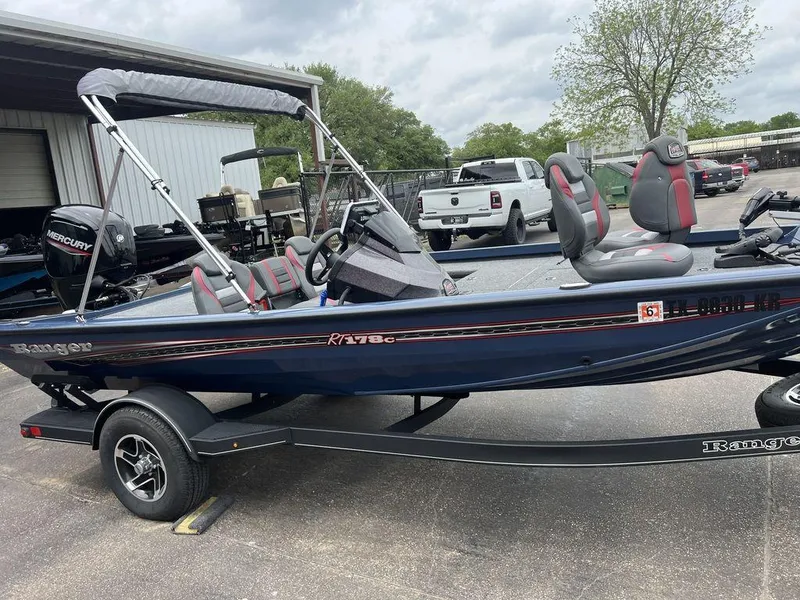 Slide: The Image of 2022 Ranger RT178C fishing boat with trailer, parked outdoors, featuring a Mercury outboard motor. - 21