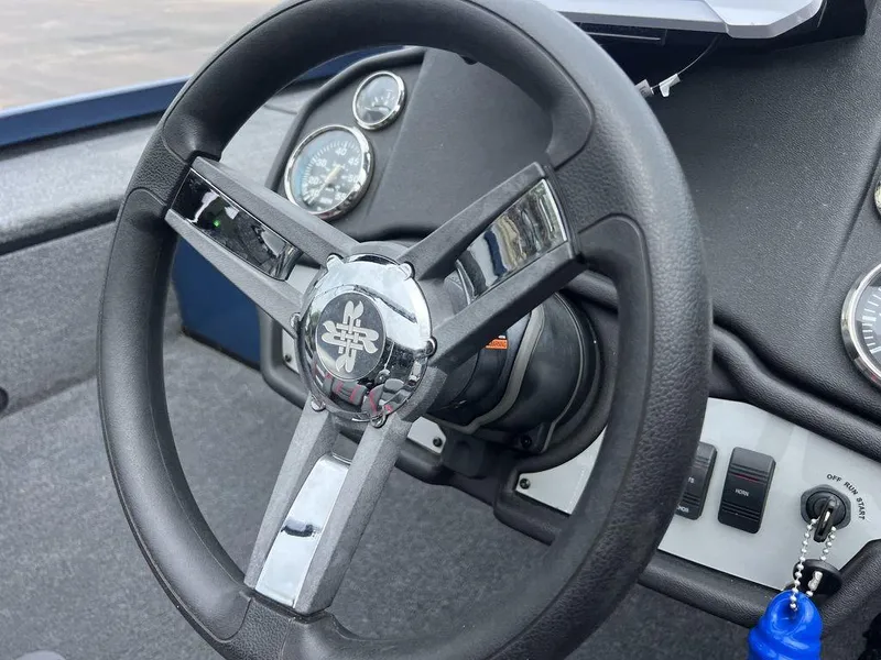Slide: The Image of Steering wheel and dashboard of 2022 Ranger RT178C boat, featuring gauges and controls. - 25