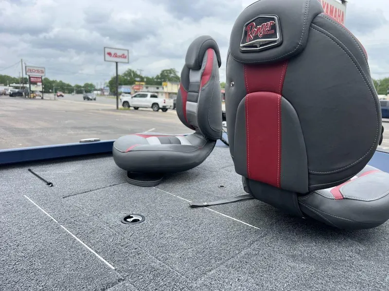 Slide: The Image of 2022 Ranger RT178C boat seats with red and gray upholstery, parked in a lot. - 28