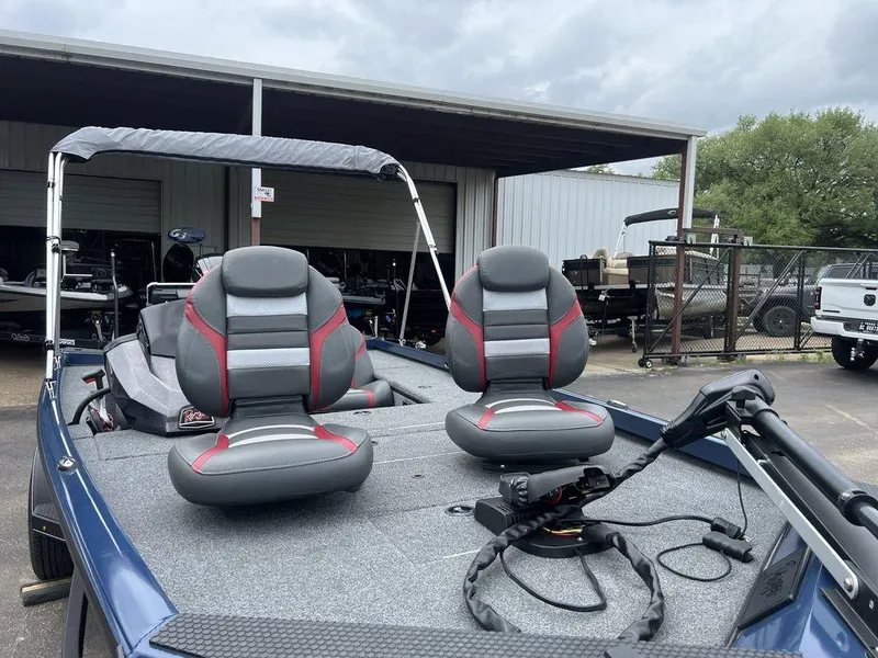 Slide: The Image of 2022 Ranger RT178C boat with dual seats and trolling motor, parked outdoors. - 32