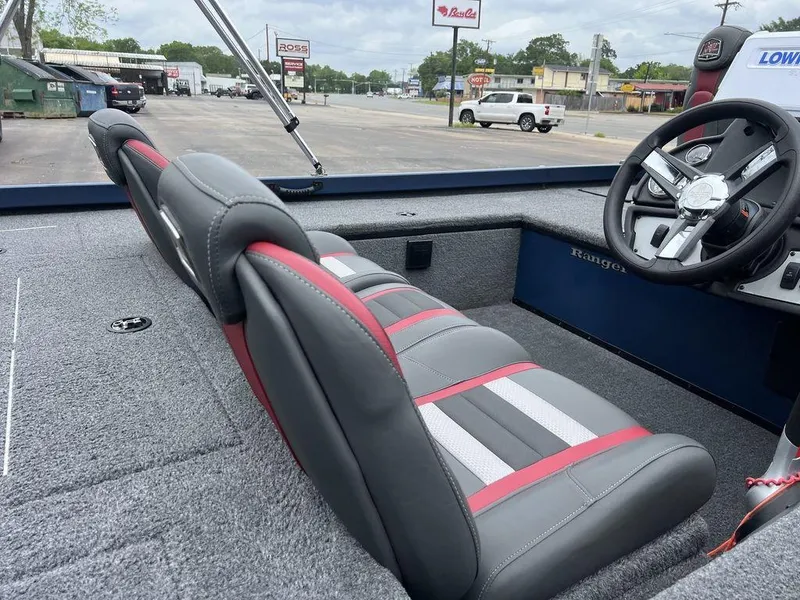 Slide: The Image of 2022 Ranger RT178C boat interior with gray and red seats, steering wheel, and carpeted deck. - 36