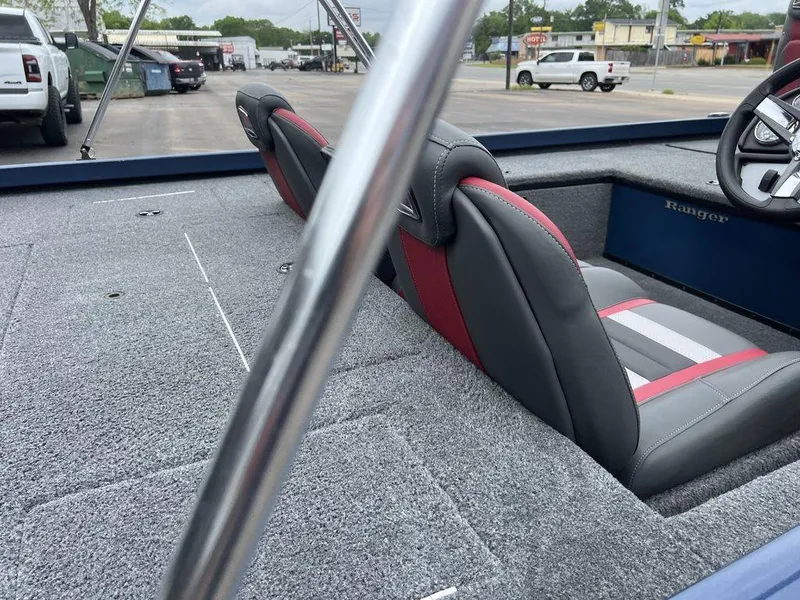 Slide: The Image of 2022 Ranger RT178C boat interior with gray and red seats, parked in a lot. - 41