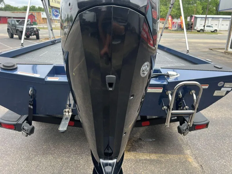 Slide: The Image of 2022 Ranger RT178C boat with outboard motor and ladder in a parking lot. - 45
