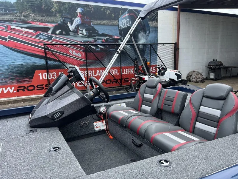 Slide: The Image of 2022 Ranger RT178C boat interior with gray and red seating, displayed at a dealership. - 9