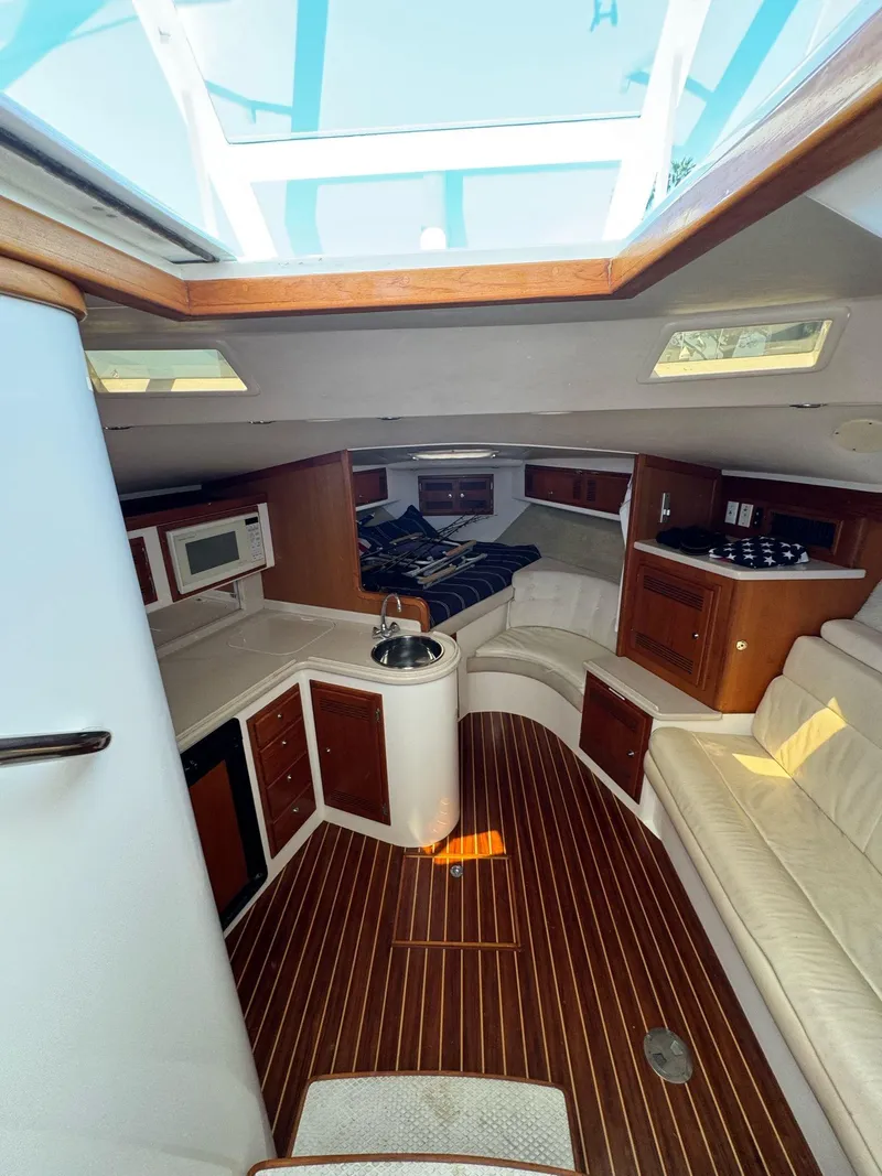 Slide: The Image of Interior of a 1998 Cabo 35 Express boat with wood flooring and modern amenities. - 14
