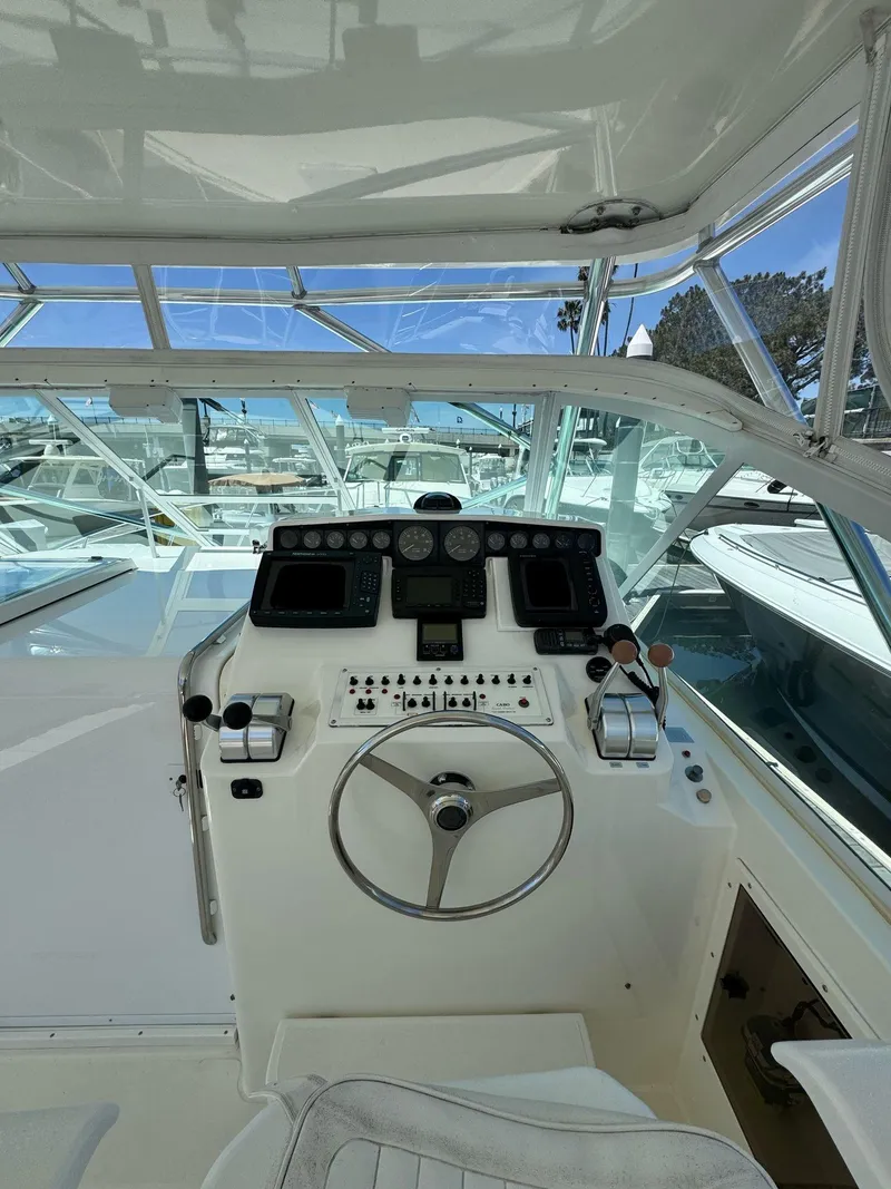 Slide: The Image of 1998 Cabo 35 Express boat helm with steering wheel and control panel. - 31