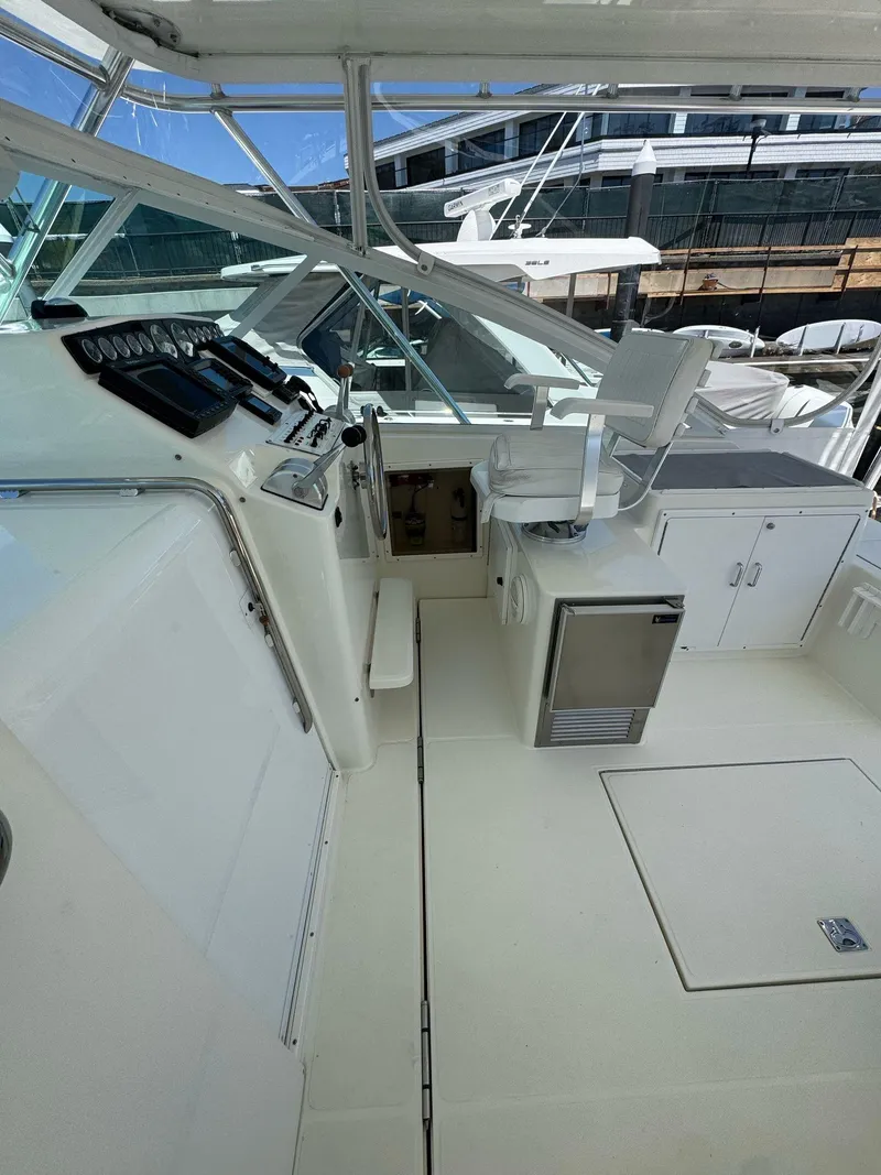 Slide: The Image of 1998 Cabo 35 Express boat interior with helm, seating, and storage. - 32