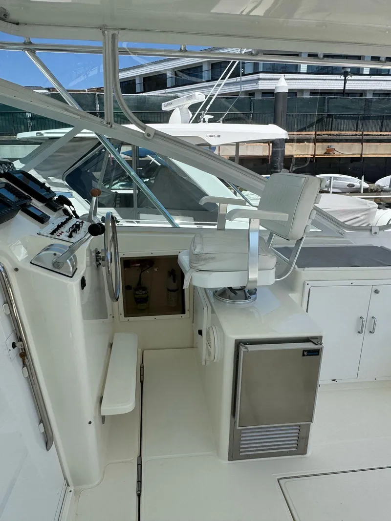 Slide: The Image of 1998 Cabo 35 Express boat cockpit with captain's chair and control panel. - 35