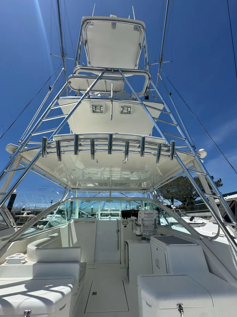 Slide: The Image of 1998 Cabo 35 Express boat with tower under clear blue sky. - 39