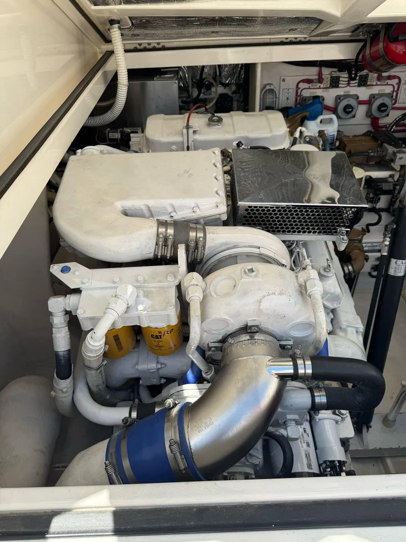 Slide: The Image of Engine compartment of a 1998 Cabo 35 Express boat, showcasing mechanical components. - 47