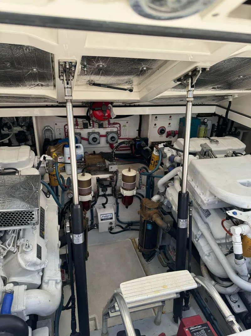 Slide: The Image of Engine room of a 1998 Cabo 35 Express boat, showcasing mechanical components. - 49
