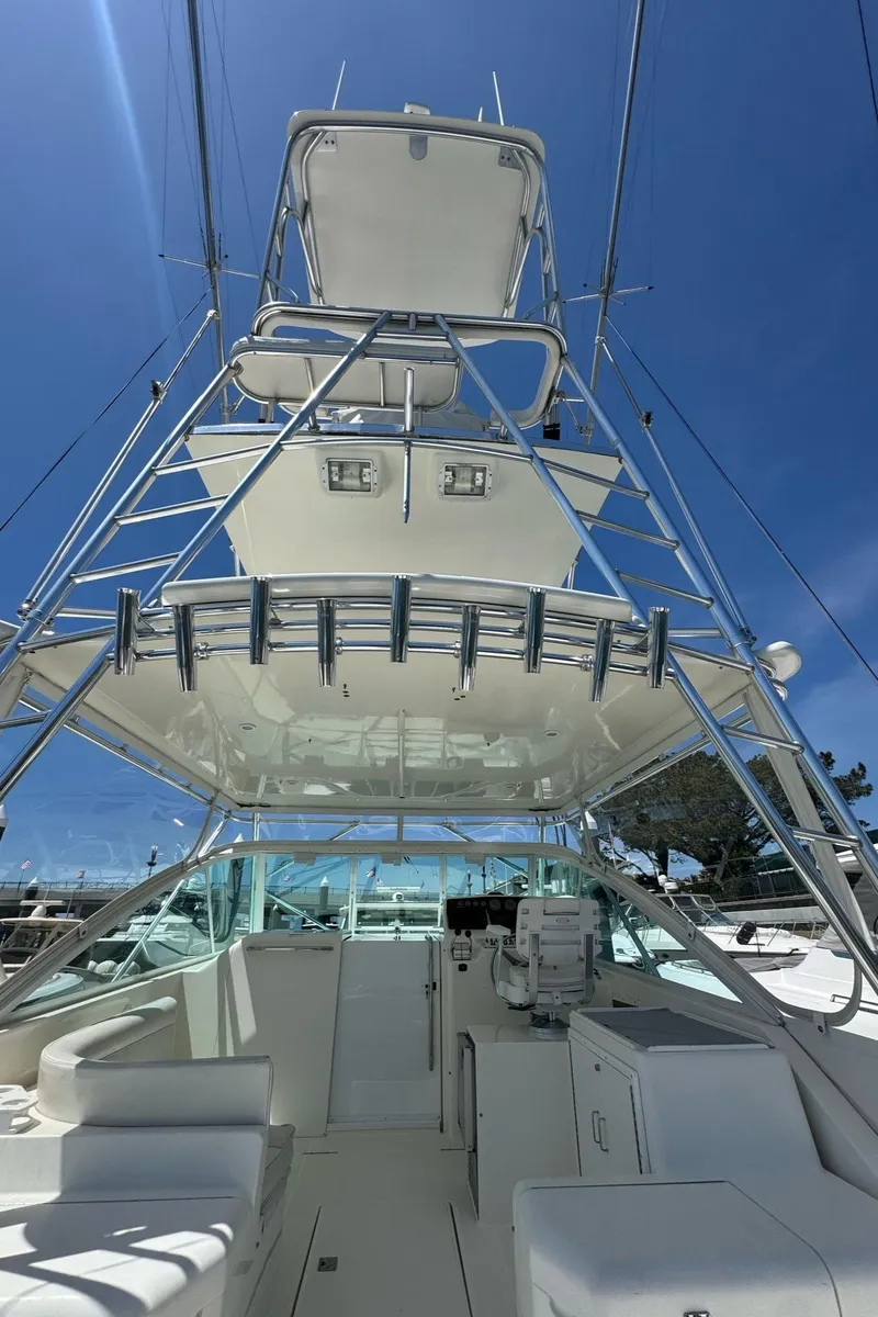 Slide: The Image of 1998 Cabo 35 Express boat with tower against clear blue sky. - 7