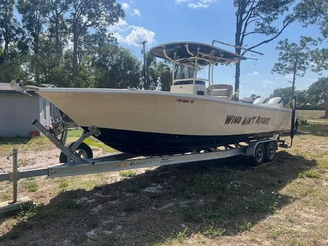 Slide: The Image of 2020 Sea Chaser 30 HFC CC boat on trailer, parked outdoors under trees. - 1