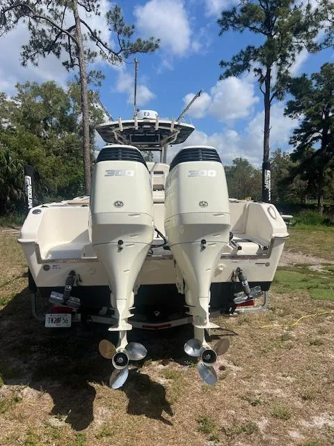 Slide: The Image of 2020 Sea Chaser 30 HFC CC boat with dual outboard engines, parked outdoors. - 10