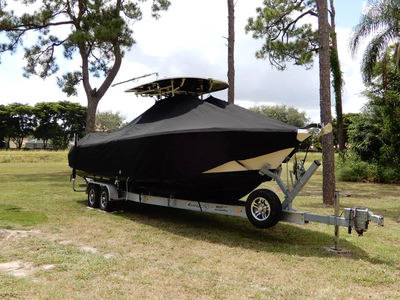 Slide: The Image of 2020 Sea Chaser 30 HFC CC boat covered on trailer, parked outdoors. - 11