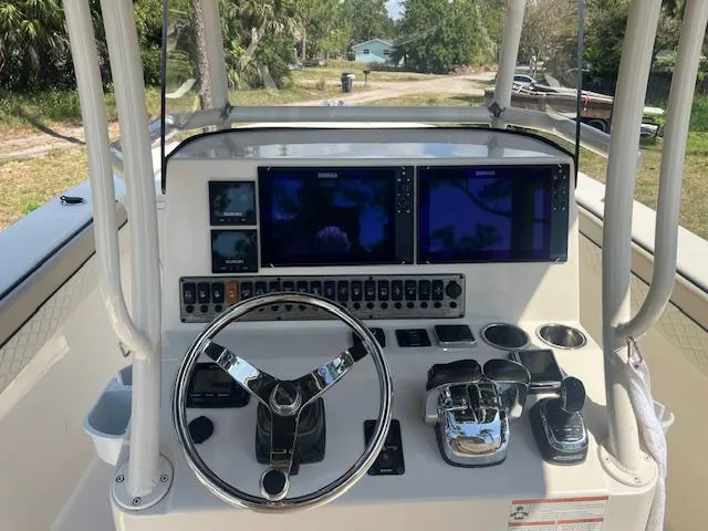 Slide: The Image of 2020 Sea Chaser 30 HFC CC boat dashboard with steering wheel and navigation controls. - 14