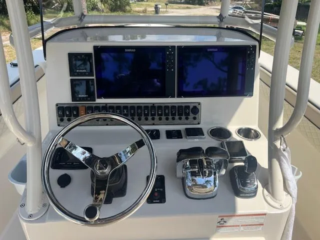Slide: The Image of 2020 Sea Chaser 30 HFC CC boat dashboard with dual screens and controls. - 16