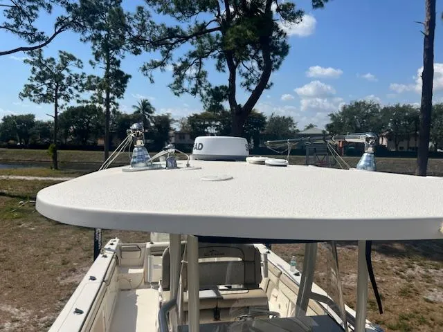 Slide: The Image of 2020 Sea Chaser 30 HFC CC boat with T-top, parked outdoors under clear sky. - 17