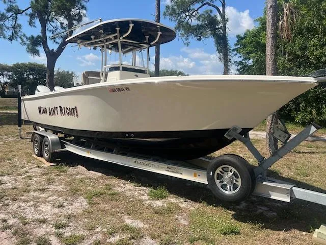 Slide: The Image of 2020 Sea Chaser 30 HFC CC boat on trailer, parked outdoors under clear sky. - 2