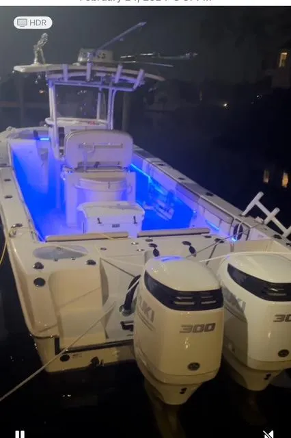 Slide: The Image of 2020 Sea Chaser 30 HFC CC boat with blue interior lights and twin 300 HP engines. - 25
