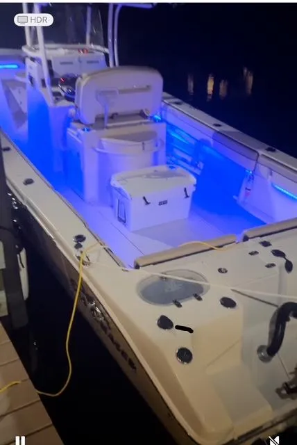 Slide: The Image of 2020 Sea Chaser 30 HFC CC boat with blue interior lighting at night. - 27