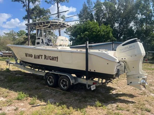 Slide: The Image of 2020 Sea Chaser 30 HFC CC boat on trailer with "Wind Ain't Right!" text. - 3
