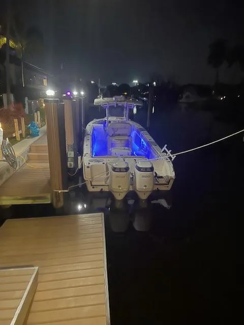Slide: The Image of 2020 Sea Chaser 30 HFC CC boat docked at night with blue interior lights. - 7