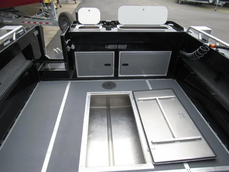 Slide: The Image of Interior of 2025 North River 23 SEAHAWK RTF boat, featuring storage compartments and sleek design. - 11