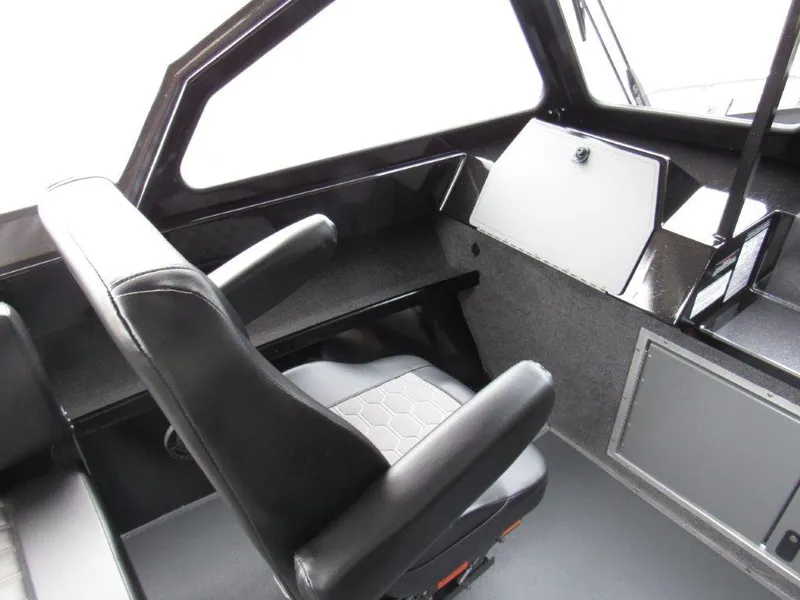 Slide: The Image of Interior of 2025 North River 23 SEAHAWK RTF boat with black seating and dashboard. - 13