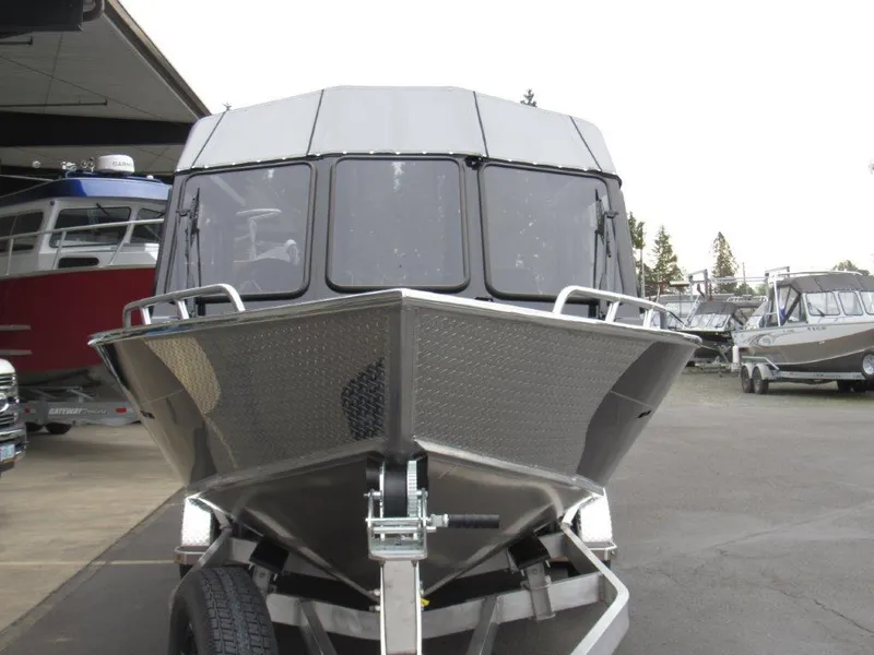 Slide: The Image of 2025 North River 23 SEAHAWK RTF boat on trailer, front view in a marina setting. - 8