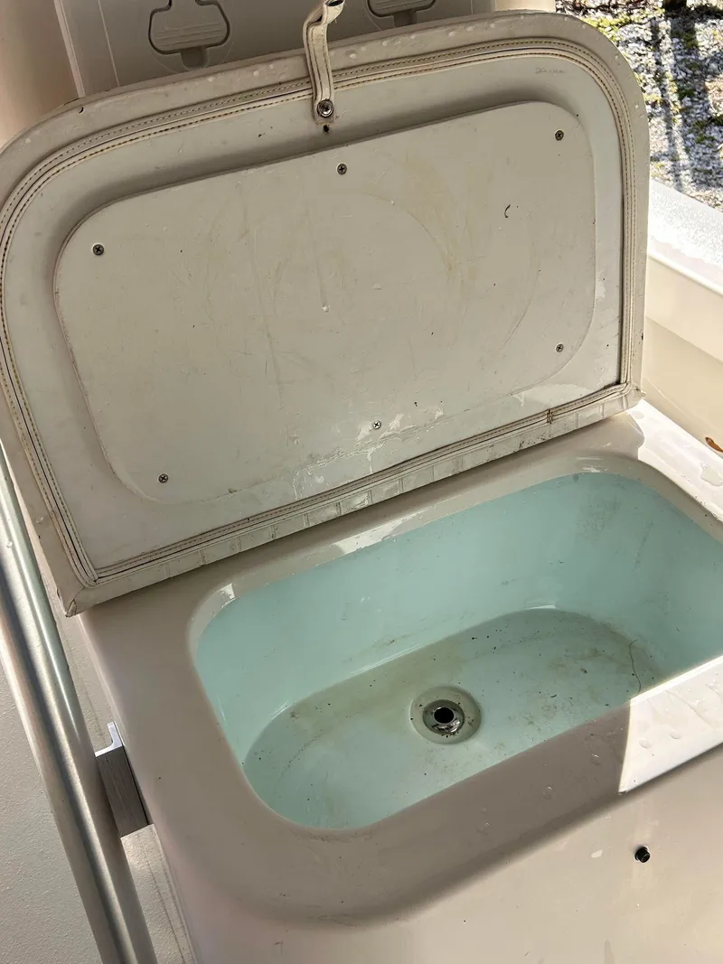 Slide: The Image of Open storage compartment on 2014 Andros Guide 20 boat, featuring a light blue interior. - 12