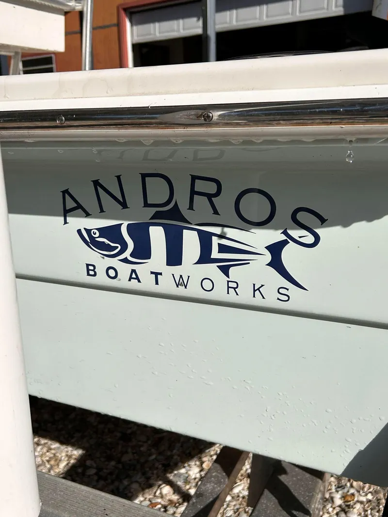 Slide: The Image of Andros Guide 20 boat logo, 2014 model, featuring a stylized fish design. - 3