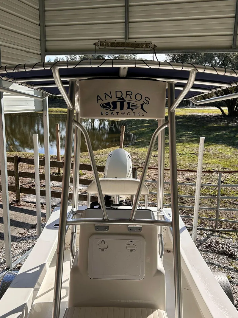 Slide: The Image of 2014 Andros Guide 20 boat under a metal shelter near a pond. - 6