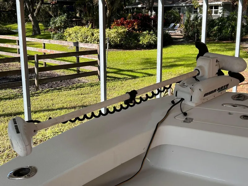 Slide: The Image of 2014 Andros Guide 20 boat with trolling motor, docked in a sunny yard. - 7