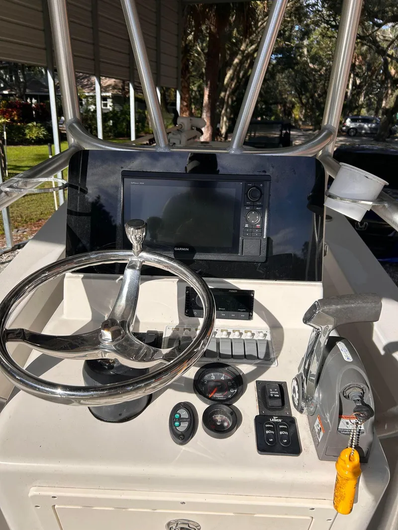 Slide: The Image of 2014 Andros Guide 20 boat dashboard with steering wheel, controls, and navigation display. - 8