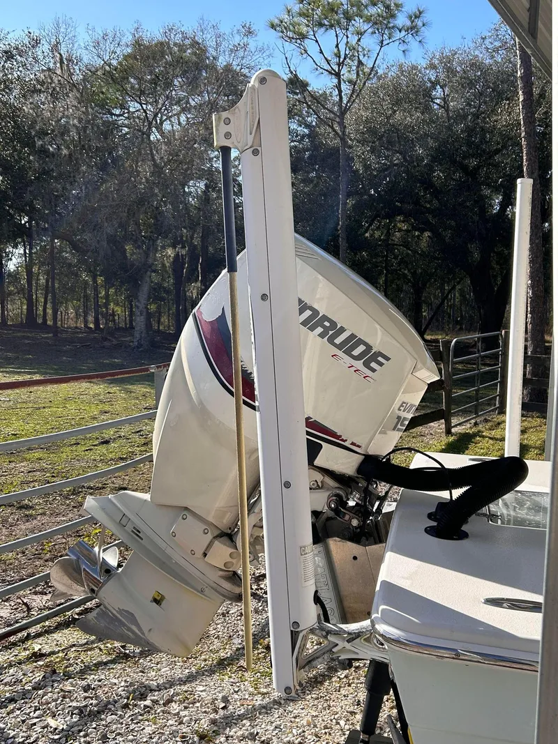 Slide: The Image of 2014 Andros Guide 20 boat with Evinrude outboard motor in a sunny outdoor setting. - 9