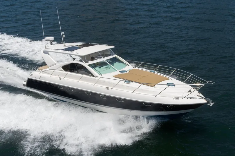 Slide: The Image of 2000 Fairline 48 Targa yacht cruising on open water, showcasing sleek design and luxury. - 0