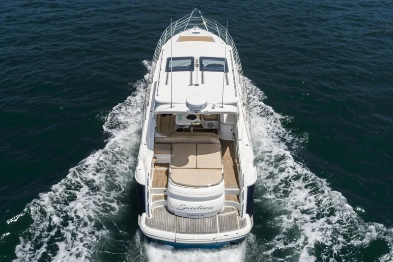 Slide: The Image of 2000 Fairline 48 Targa yacht cruising on open water, aerial view. - 12